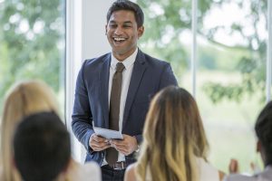 man standing to present holding tablet