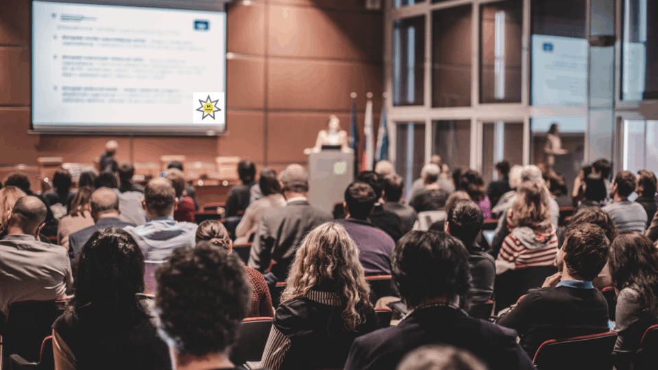 woman presenting to audience on lectern