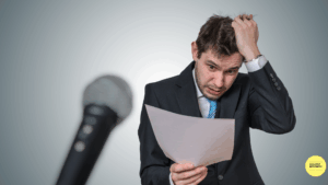Nervous speaker with notes and microphone