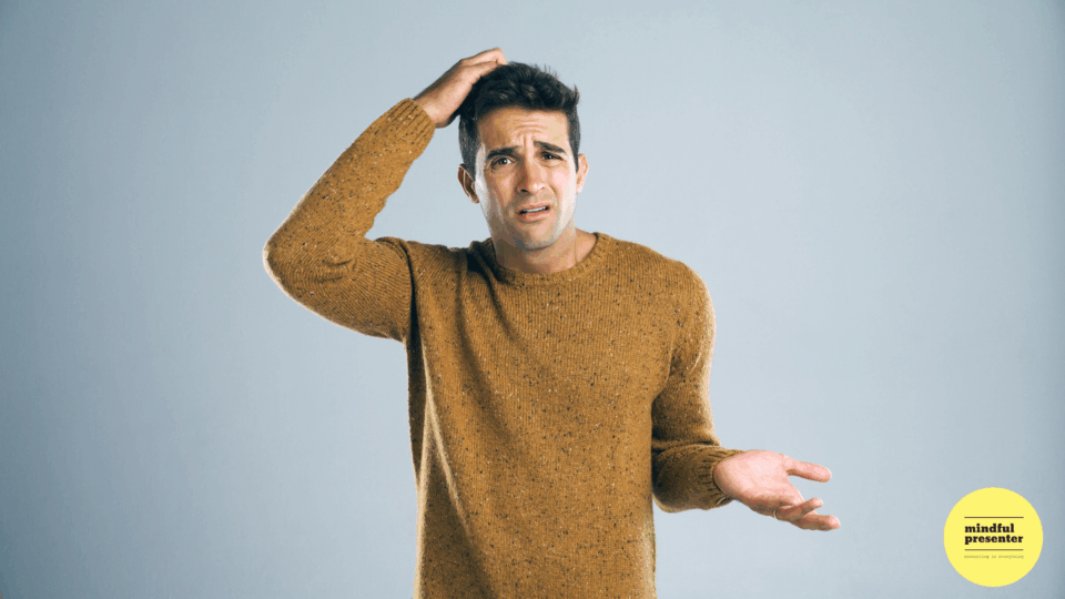 man with hand on head looking confused