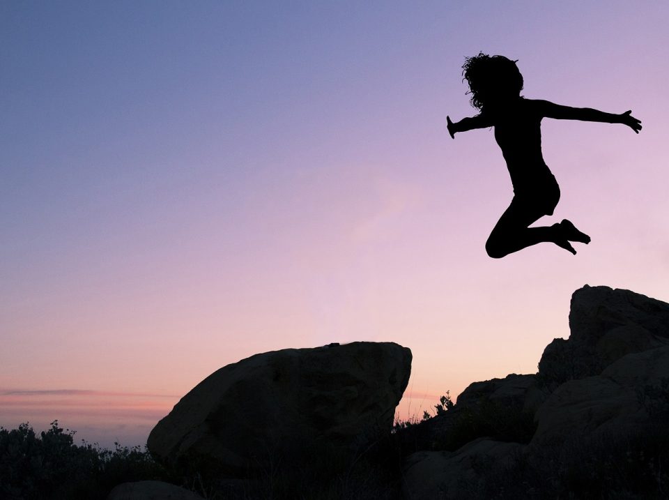 girl jumping off hill