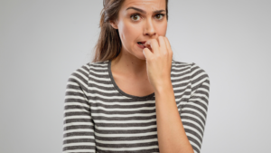 nervous woman biting nails