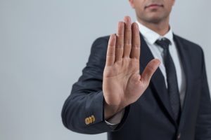 Businessman showing stop with hand