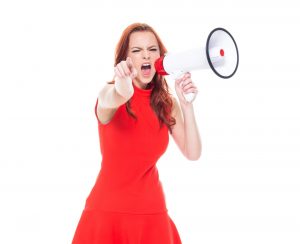 woman in red dress pointing while holding megaphone