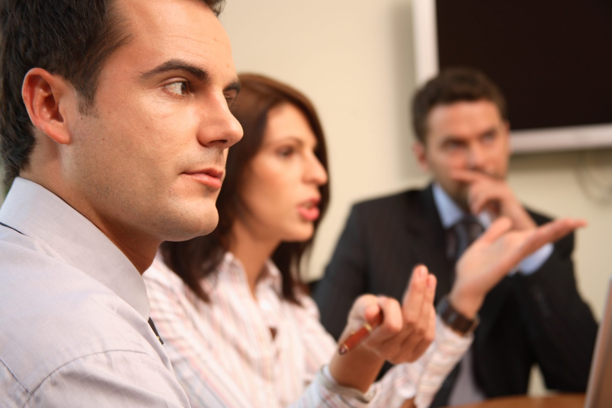 Two men and a woman in ameeting