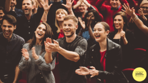 audience standing clapping and smiling