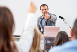 presenter point at audience member with hand up