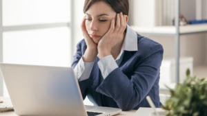 woman looking bored at laptop