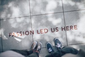 two pairs of feet standing next to the words'passion led us here'