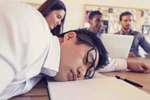 man sleeping on desk