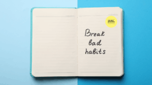 Open note book with the words 'break bad habits. written down.