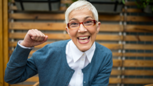 woman smiling punching the air