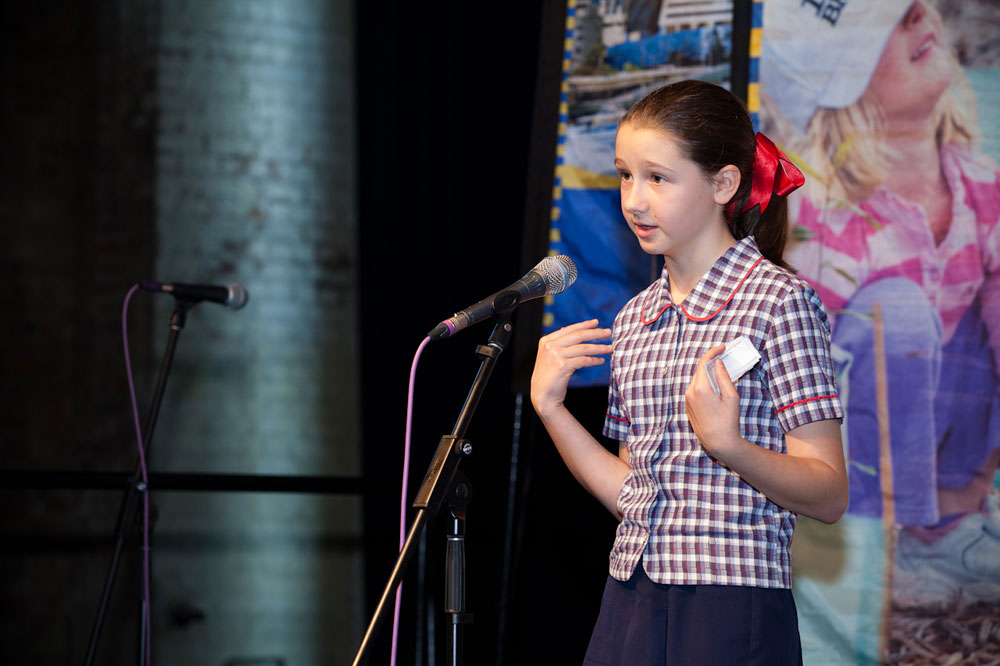 Young girl speaking with microphone