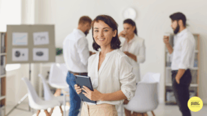Woman standing in front of people holding blue book