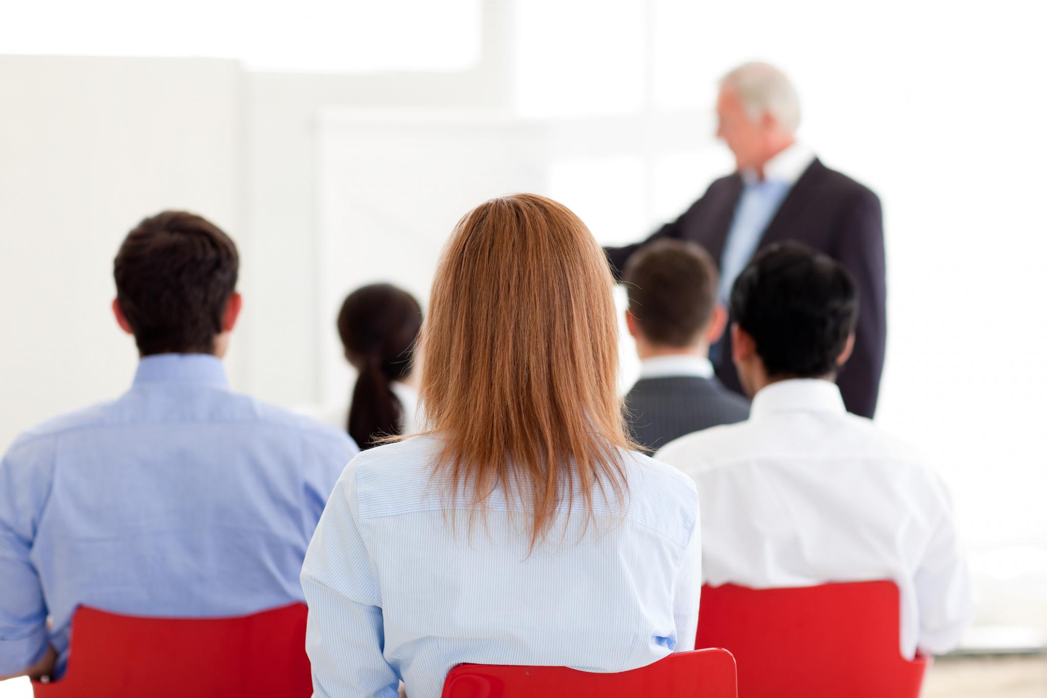 man presenting to a group of people seated