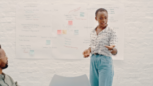 woman presenting using a white board