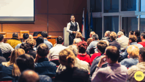 man presenting to large audience