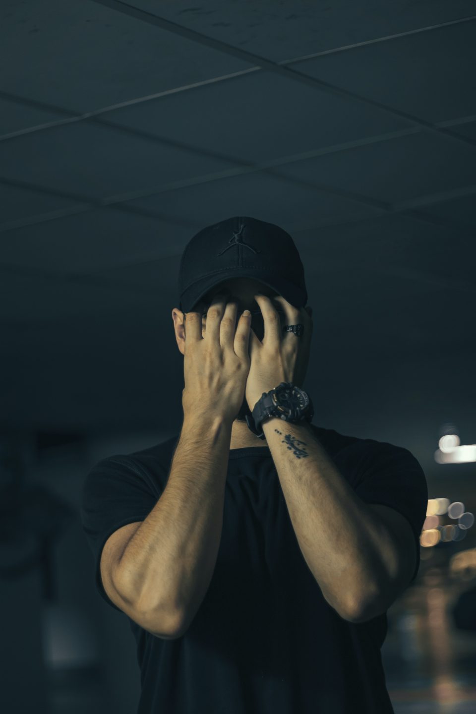 man with hands covering face