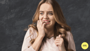 Woman biting nails looking scared