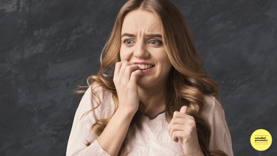 Woman biting nails looking scared