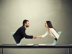 man and woman coming out of laptop screens