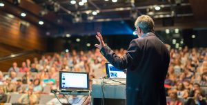 Man presenting at a conference