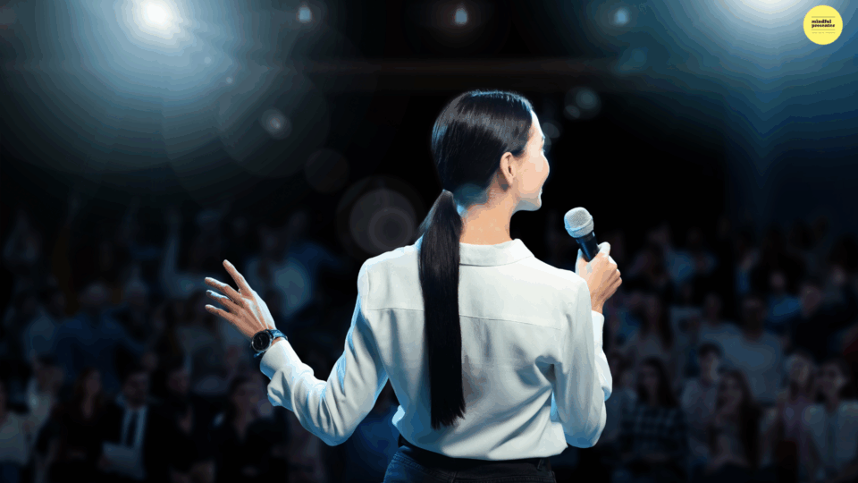 woman speaking on stage with micropphone