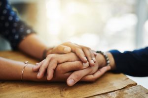 two females holding hands