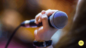 mans hand holding microphone