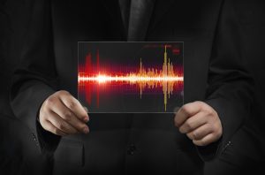 man holding chart of sound waves