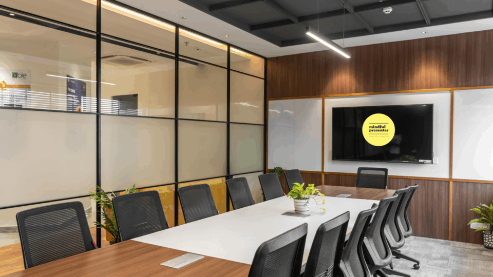 Boardroom table with screen with Mindful Presenter Logo on it