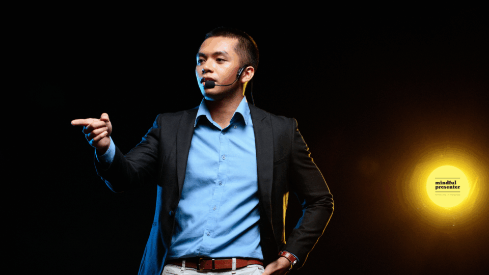 man presenting with with hands free microphone pointing finger