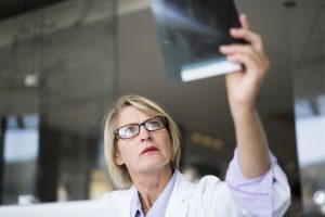 female doctor looking at an xray