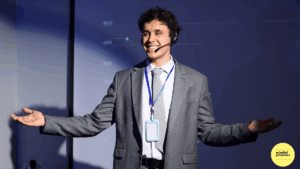 man smiling at audience with his arms wide open