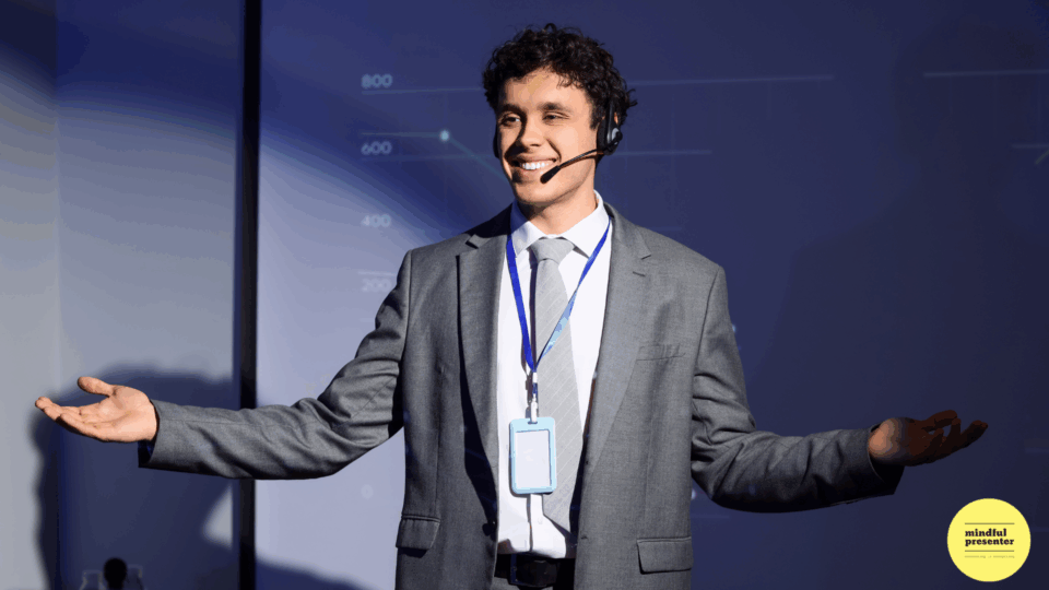 man smiling at audience with his arms wide open