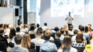 Person presenting to large audience