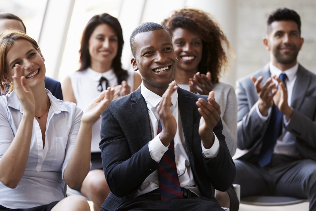 audience smiling and applauding