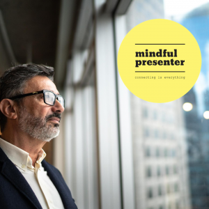 Business man looking out of window at mindful presenter logo