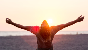 woman with outstretched arm in sunset