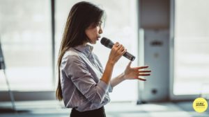 woman speaking into microphone
