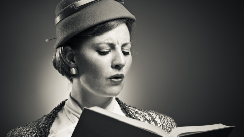 black and white photo of woman reading a book