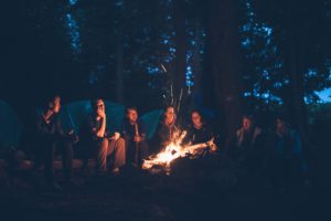 group storytelling around open fire