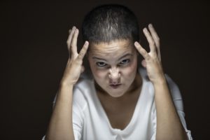 girl with hands up looking angry