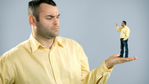 man holding smaller version of himself in his hand