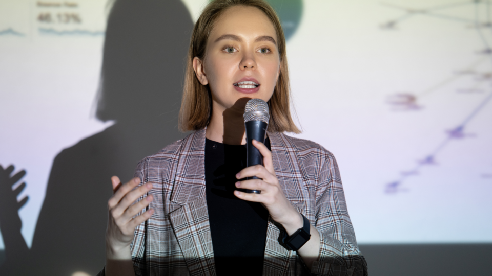 woman public speaking with a microphone