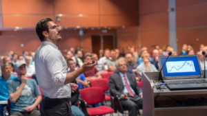 man presenting slides to audience