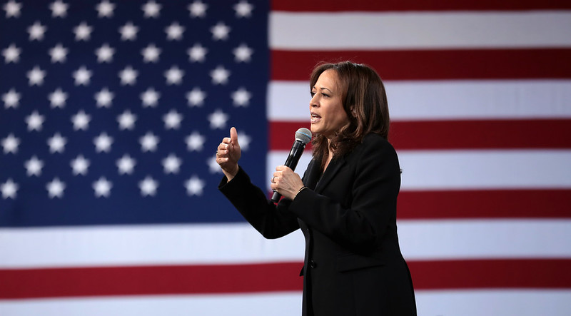 Kamala Harris speaking in front of US flag