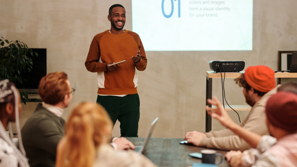 man presenting to audience using slides