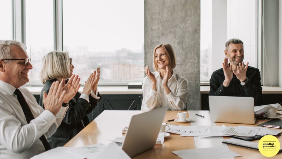people clapping in a meeting