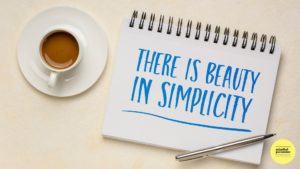 Note pad with the words. 'There is beauty in simplicity' Cup of coffee and pen